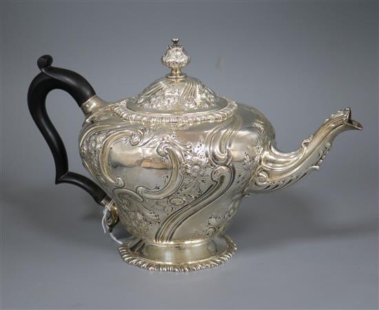 A Victorian embossed silver inverted pear shaped teapot, London, 1890, gross 25 oz.